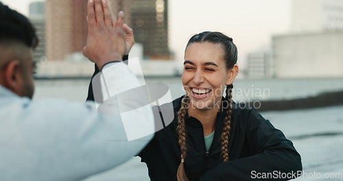 Image of Happy couple, celebration or high five on rooftop for fitness exercise or workout together with pride or smile. Athletes, motivation or excited or man with woman, support or goal on building in city