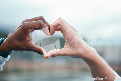 Image of Outdoor, closeup and people with heart sign, hands and support with kindness, emoji and commitment. Outside, couple or interracial with symbol for love, trust and partnership with care, icon and like