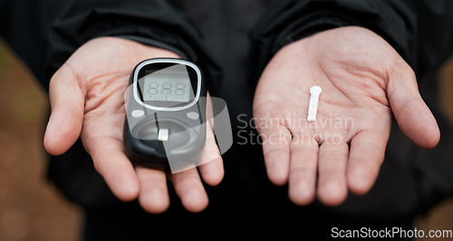 Image of Closeup, hands and equipment for diabetes check, glucose and test for blood and health analysis. Healthcare, digital and electronic medical tools to monitor sugar, insulin or treatment for safety