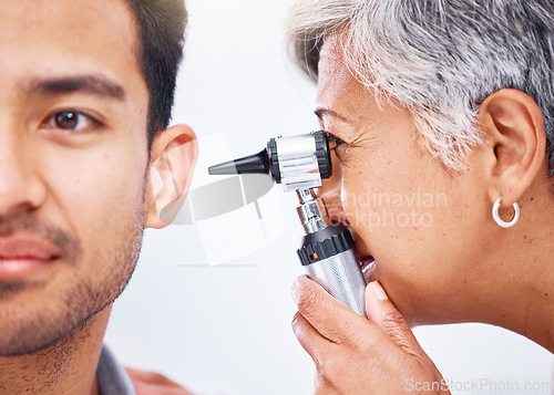 Image of Hearing test, doctor and patient with healthcare consultation closeup, face and ENT specialist with otoscope. Medical professional, assessment and trust with man and senior woman with ear check