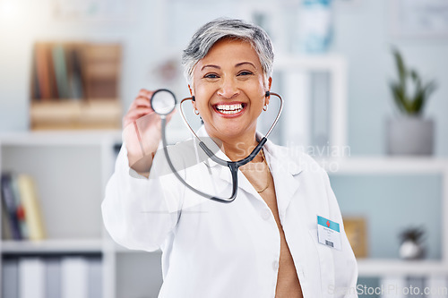 Image of Doctor, woman and portrait with stethoscope for heartbeat, healthcare services or cardiology. Happy mature medical surgeon consulting with tools for listening, check breathing or test lungs in clinic