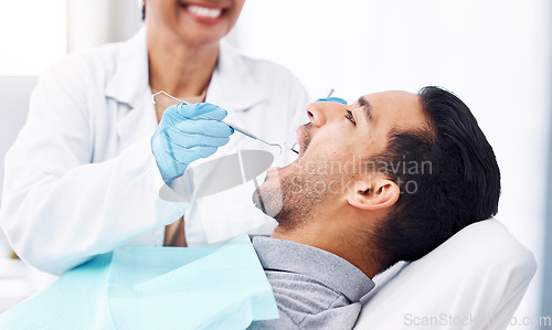 Image of Man, dentist and check teeth with tools for dental cosmetics, healthcare assessment or medical consulting. Patient, tooth or open mouth in oral cleaning with mirror, excavator or orthodontics surgery