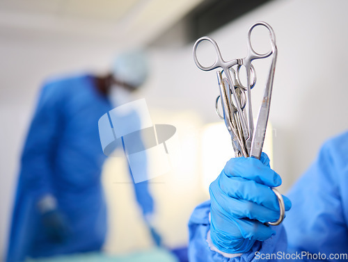 Image of Hand, scissors and a doctor in a hospital or theatre to start operation with surgical tools. Zoom on a surgeon, assistant or staff with sterile equipment for medical procedure or emergency healthcare