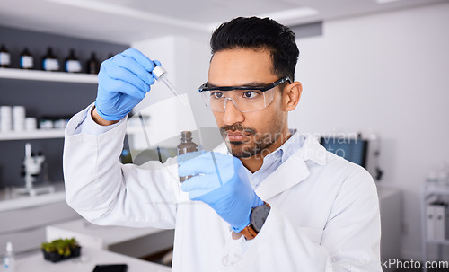 Image of Scientist, man and bottle, pipette and chemical solution with medical research, investigation and goggles for safety. Chemistry, liquid and science in laboratory, future and biotechnology with study