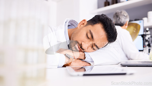 Image of Asian man, scientist and sleeping on desk in laboratory, burnout or overworked in mental health. Tired male person, medical or healthcare worker asleep in lab rest, dreaming or fatigue at workplace