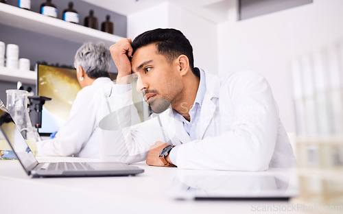 Image of Scientist, stress and headache for computer research, planning and data analysis, mistake or healthcare results. Sad or tired science man or doctor working on laptop in medical or medicine laboratory