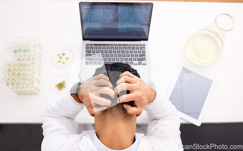 Image of Man, scientist and laptop with headache in stress, anxiety or mistake and mental health in biology above at lab. Top view of male person, medical or healthcare research in burnout, depression or fail