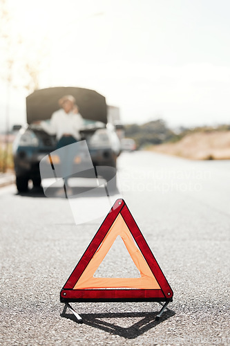 Image of Car problem, stop sign or driver with stress or anxiety late from engine crisis on road or street. Blur, phone call or frustrated black woman talking by a stuck motor vehicle in emergency or accident