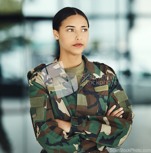 Image of Military, thinking and arms crossed with a woman soldier in uniform for safety, service or patriotism Army, idea and a serious young war hero looking confident or ready for battle in camouflage