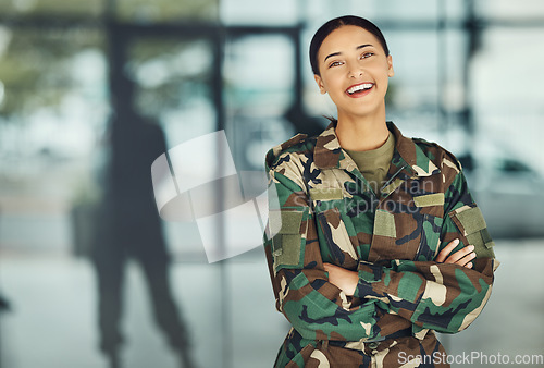 Image of Portrait of woman soldier with smile, confidence or pride, outside army mockup with arms crossed. Professional military career, security and courage, girl in camouflage uniform at government agency.
