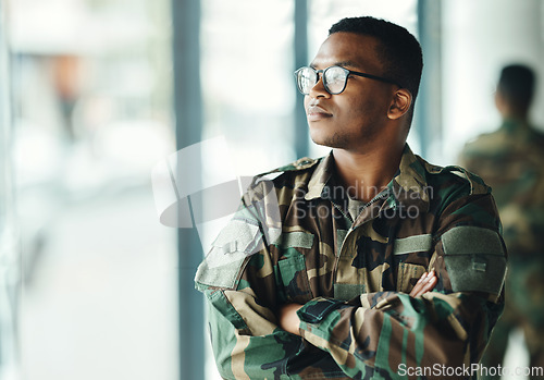 Image of Confident soldier thinking, mockup and arms crossed in army building, pride and professional hero service. Military career, security and courage, black man in camouflage uniform at government agency.