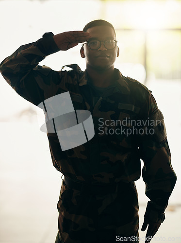 Image of Confident soldier portrait, army and salute in building with pride, professional hero and night service. Military career, security and courage, black man in camouflage uniform at government agency.