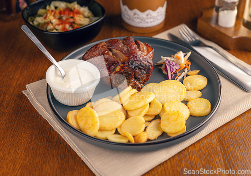 Image of Roasted pork knuckle with potatoes