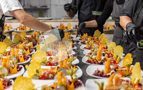 Image of Cooks are garnishing appetizer plates