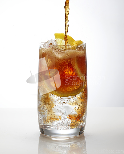 Image of cola pouring into cocktail glass