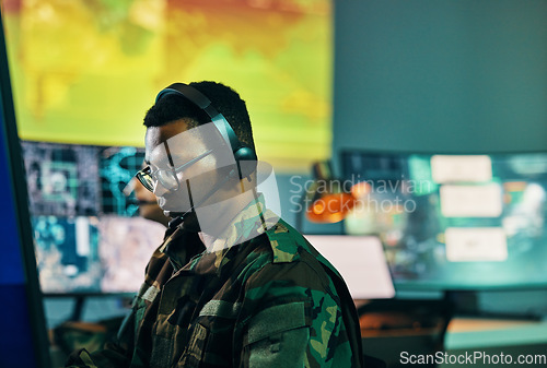 Image of Military, control room and man on computer in office, data center and monitor for technical support, cybersecurity or surveillance. Army, officer and work in tech, security or government communicatio