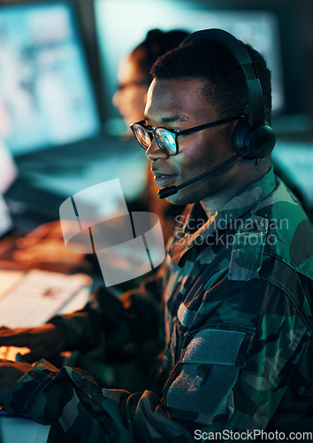 Image of Military, call center and man on computer in office, data center and monitor for technical support, cybersecurity or surveillance. Army, officer and work in tech, security or government communication