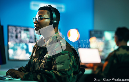 Image of Army, control room and man on computer in office, data center and monitor for technical support, cybersecurity or surveillance. Military, officer or work in tech, security or government communication