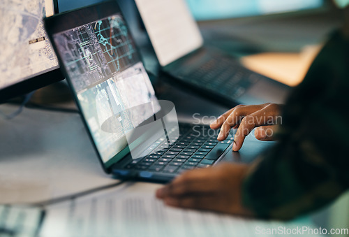 Image of Hands typing, laptop and closeup on table of military intelligence, map and research on internet. Computer, soldier and veteran online for surveillance, cyber security and info of army professional