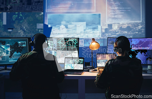 Image of Military control room, computer screen and team with surveillance, headset and tech communication from back. Security, satellite map and man with woman at monitor in army office at command center.