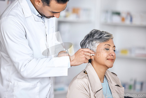 Image of Hearing aid, medical and consulting with doctor and woman with a disability for healthcare, technology and sound waves. Medicine, wellness and audio with people and cochlear implant for treatment