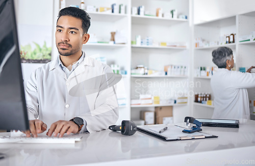 Image of Pharmacist, computer and man typing, inventory and connection with network, website information and wellness. Person, staff and employee with a pc, online reading and search internet with telehealth