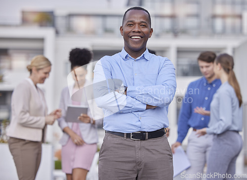 Image of Black man, portrait and hands crossed for leadership and teamwork outside office building with collaboration. Business, people and professional employee in human resources and corporate startup