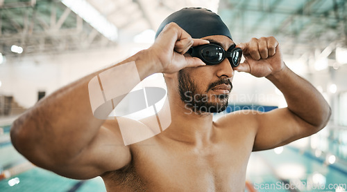 Image of Getting ready, man and goggles for swimming training, competition or a race in the pool. Fitness, gym and an athlete or swimmer with glasses to start exercise, workout or cardio in a triathlon