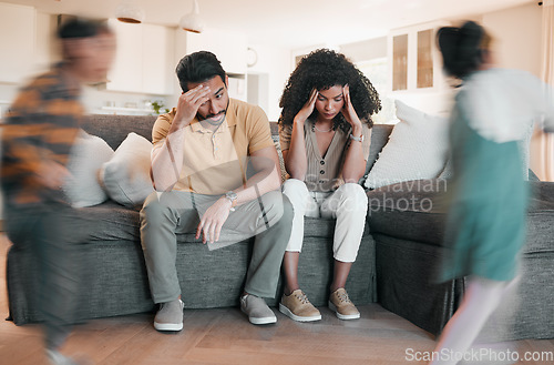 Image of Frustrated parents, headache and children with stress in burnout, anxiety or depression in living room chaos at home. Couple, family and busy ADHD kids or siblings running around sofa in crazy house