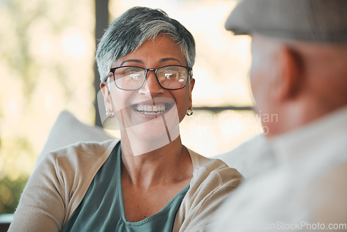 Image of Conversation, smile and senior couple on a sofa for relaxing, communication or bonding together. Happy, love and elderly woman in retirement talking to her husband in the living room of modern home.