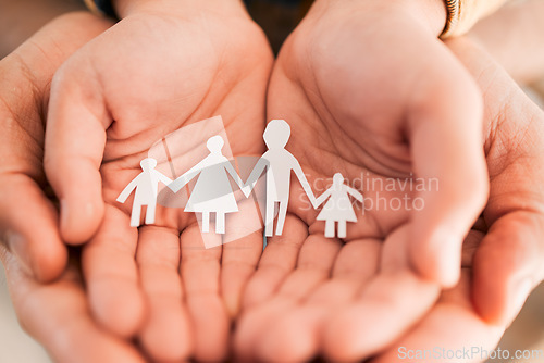 Image of Paper cutout, family and hands of people together for security, adoption or foster care. Zoom of parents and children figure in palm for love, art or support for health insurance, charity or wellness