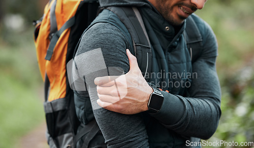 Image of Shoulder pain, hiking injury and person hand outdoor with fitness, workout and travel accident. Athlete, arm bruise and fail from trekking in the woods on a trail with muscle strain and backpack