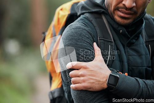 Image of Shoulder pain, injury and person hands with fitness, workout and travel accident from hike. Athlete, arm bruise and fail from trekking in the woods on a trail with muscle strain and backpack