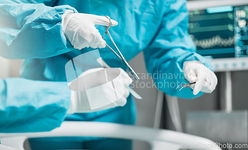 Image of Surgery, hands on tools and doctor in cutting thread with scissors, teamwork and support in hospital. Nurse helping medical surgeon, safety and stitches in operation for emergency healthcare in ER.