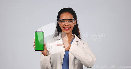 Image of Woman, scientist and green screen of phone in studio for advertising, research app or information on white background. Portrait, science or pointing to tracking markers on smartphone for data results