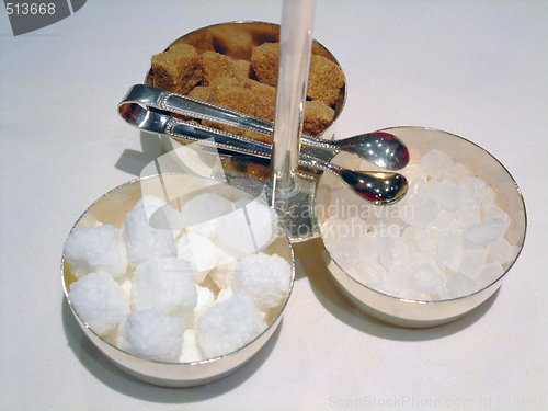 Image of cane sugar, white sugar and candy sugar cubes with tongs