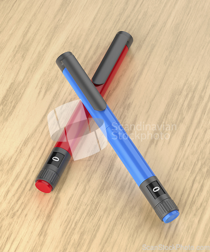 Image of Blue and red insulin pens