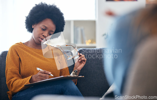 Image of Therapist on sofa, writing notes with patient, advice and help in psychology, listening and mental health care. Conversation, support and black woman on couch with client, psychologist in counseling.