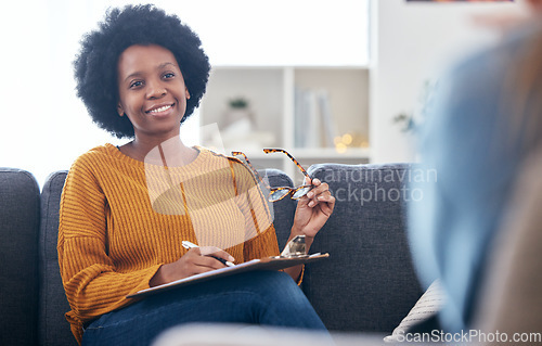 Image of Psychologist on couch, writing notes with patient, advice and help in psychology, listening and mental health care. Conversation, support and black woman on sofa with client, therapist in counseling.