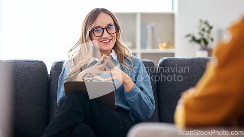 Image of Therapist on sofa with notes, listening to patient in therapy and advice in psychology for mental health care. Conversation, support and woman on couch with client, happy psychologist in counseling.