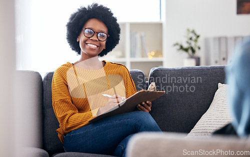 Image of Black woman therapist on sofa with notes, smile and patient for advice and psychology, listening and mental health care help. Conversation, support and psychologist on couch with client in counseling