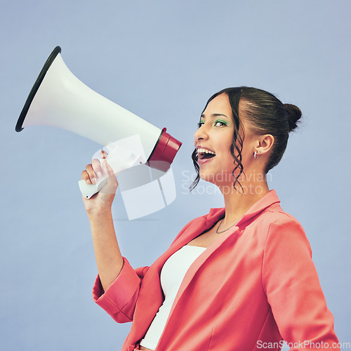 Image of Megaphone, speech and face of happy woman in studio with announcement, deal or promo on blue background. Microphone, noise and female speaker with bullhorn for attention, information or voice vote