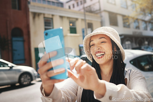 Image of Happy woman on street with phone, live streaming in city and travel holiday blog for social media post. Influencer, streamer or gen z girl with urban fashion, smartphone and smile in content creation