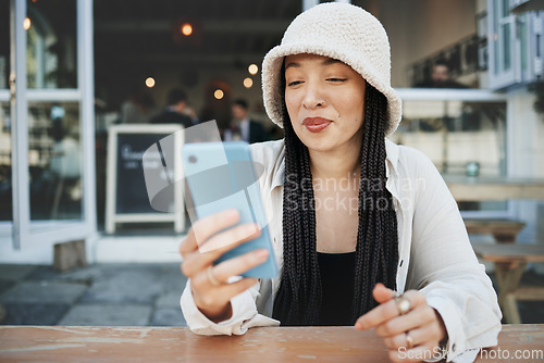 Image of Student, travel and woman with phone at a cafe for social media, texting or chatting in a city. Smartphone, app and lady influencer at coffee shop for content creation, podcast or traveling blog post