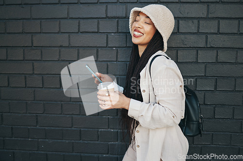 Image of Happy woman with phone, brick wall and urban fashion, typing social media, chat and laughing. Streetwear, gen z girl or online influencer with smartphone for content creation and meme communication.