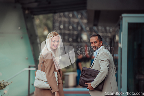 Image of Modern business couple after a long day's work, walking together towards the comfort of their home, embodying the perfect blend of professional success and personal contentment.