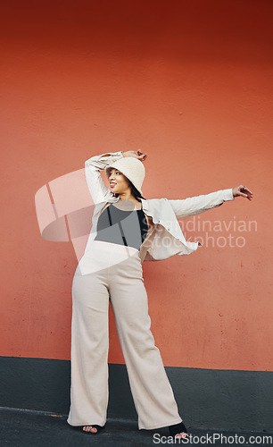 Image of Happy woman, fashion and city wall with freedom, hipster style and urban clothes with confidence. Red background and stylish female person in town with cool and streetwear outfit and thinking