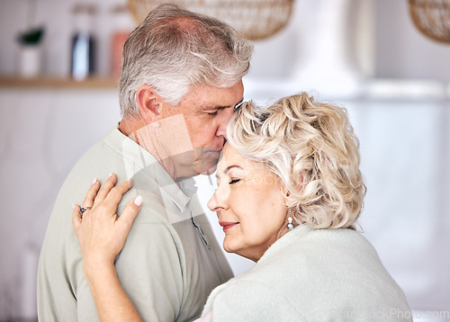 Image of Hug, support and forehead kiss by senior couple with love, security and comfort in their home. Romance, retirement and elderly man embrace old woman with soulmate, connection and intimacy in a house