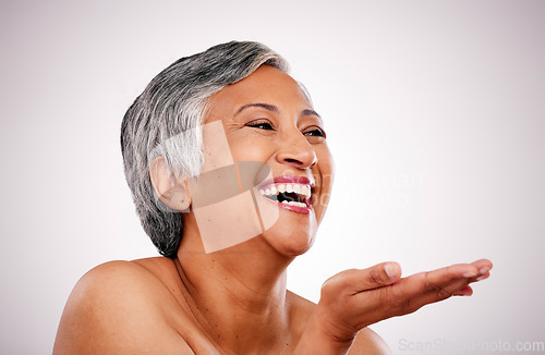 Image of Skincare face, mature woman and laugh at funny anti aging treatment, self care shine or morning skin routine, hygiene or grooming. Studio comedy, makeup palm gesture and person on white background