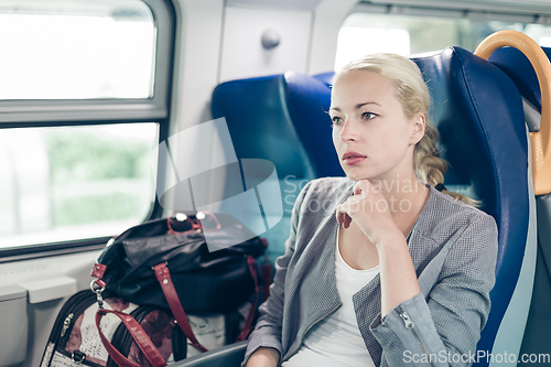 Image of Blonde business woman traveling by train.